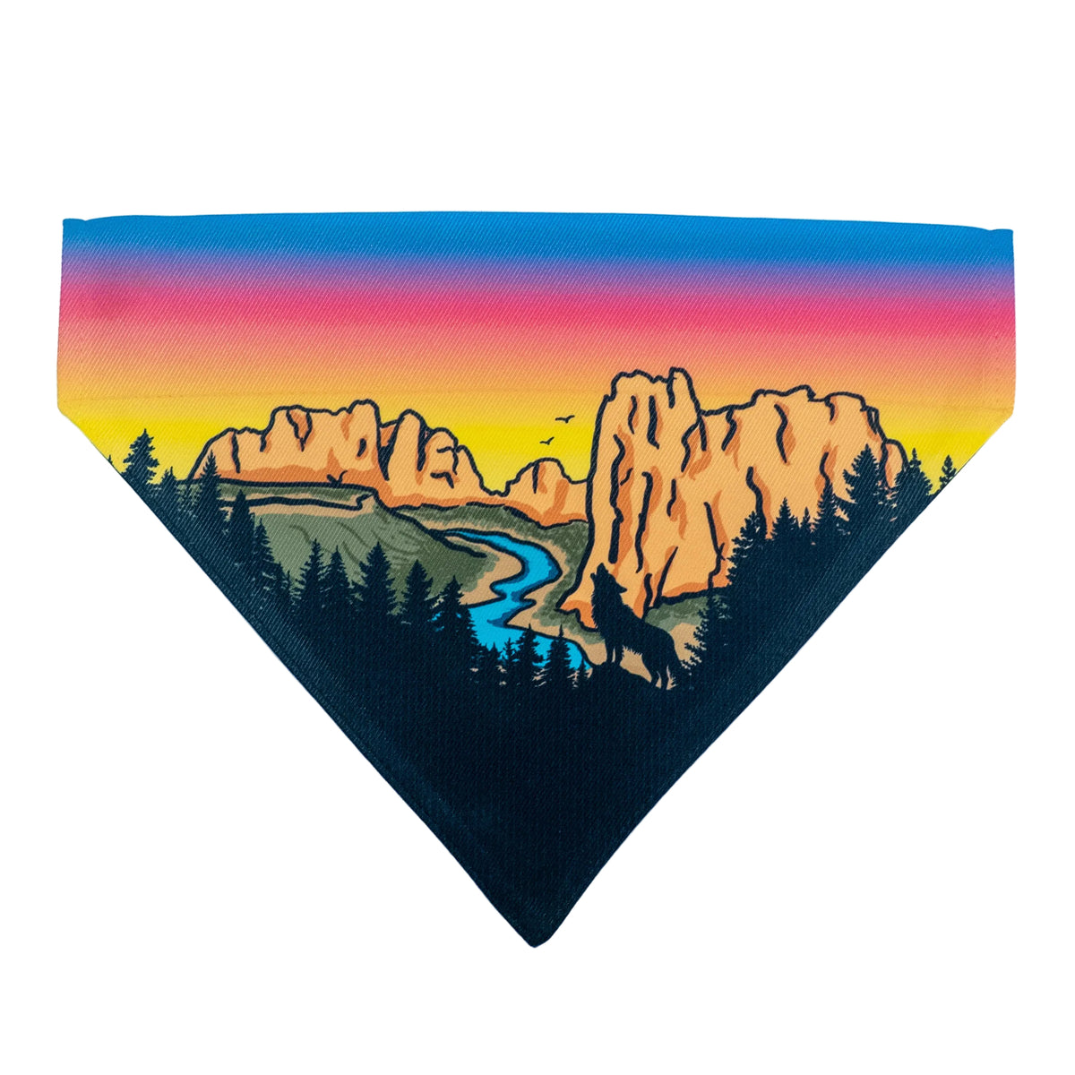A triangular pet bandana featuring a colorful landscape print with a sunset gradient sky, mountains, a winding river, and dark pine trees on a white background.